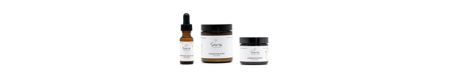 Sans Skincare products – Nourish Face Serum, Whipped Body Butter, and Whipped Face Butter with CoQ10 in amber glass jars and bottle