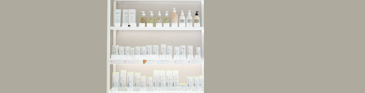 Display shelves with rows of skincare and body care products, including boxed treatments and bottled liquid soaps