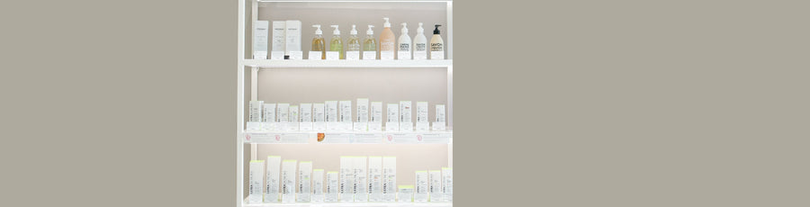Display shelves with rows of skincare and body care products, including boxed treatments and bottled liquid soaps