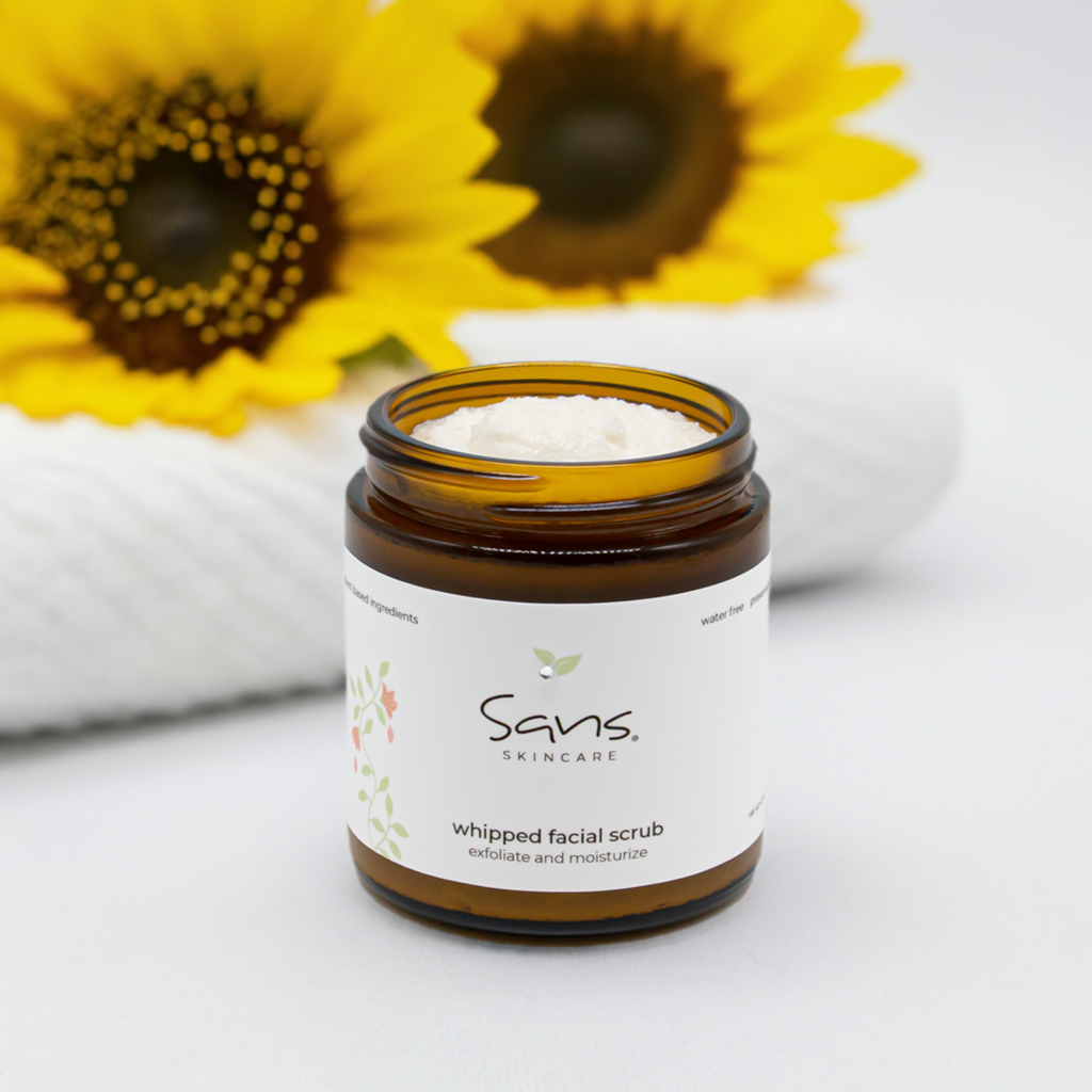 Sans Skincare Whipped Facial Scrub in amber jar with lid off, creamy natural exfoliating scrub that smooths and moisturizes skin